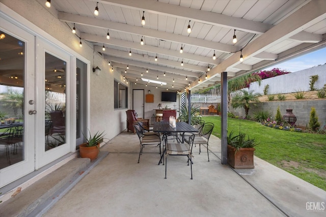 view of patio featuring french doors, a fenced backyard, and outdoor dining area