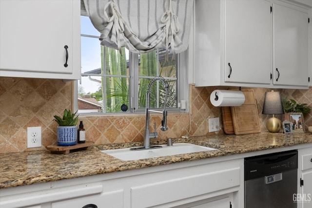 kitchen with white cabinets, tasteful backsplash, dishwasher, and a sink