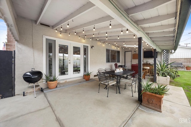 view of patio with grilling area, french doors, and outdoor dining area