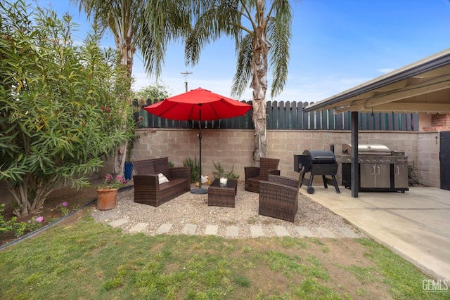 view of patio with fence and a grill