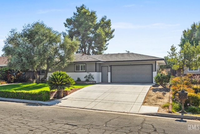 ranch-style house featuring a front yard and a garage