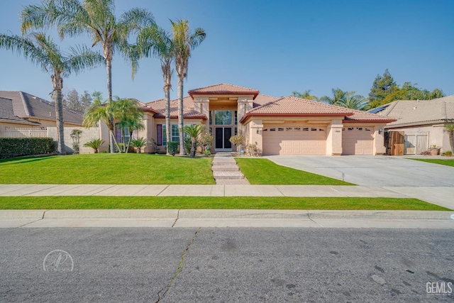 mediterranean / spanish-style home featuring a garage and a front lawn