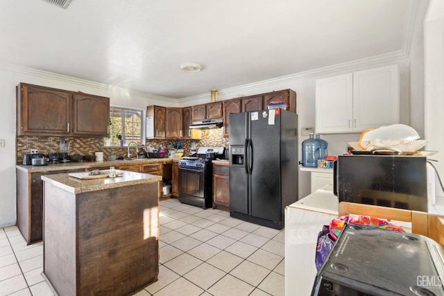 kitchen featuring light tile patterned flooring, sink, ornamental molding, dark brown cabinetry, and black appliances