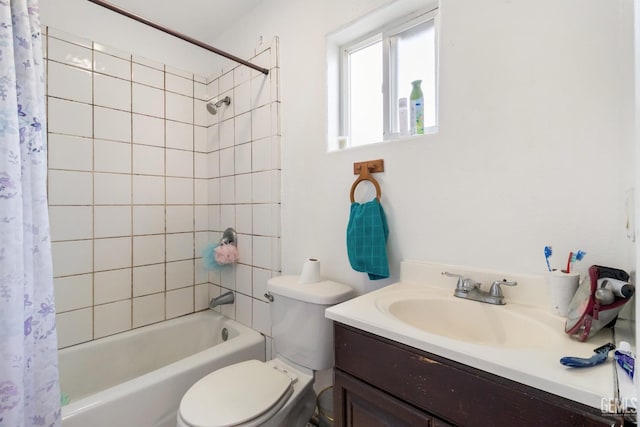 full bathroom with vanity, shower / tub combo with curtain, and toilet