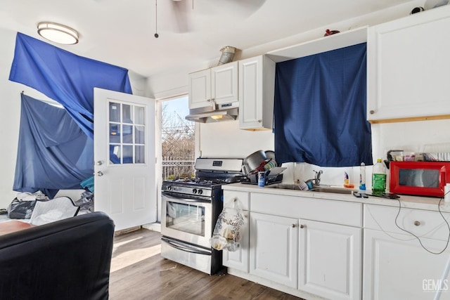 kitchen featuring white cabinetry, sink, and stainless steel range with gas stovetop