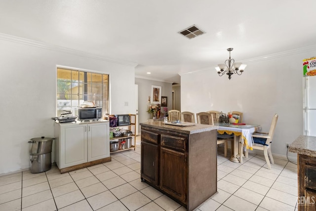 kitchen with light tile patterned flooring, pendant lighting, dark brown cabinets, and a center island with sink