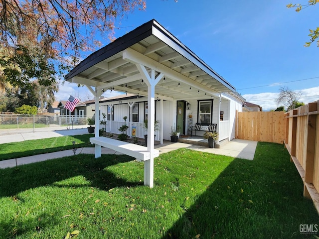 exterior space featuring covered porch, fence private yard, and a yard