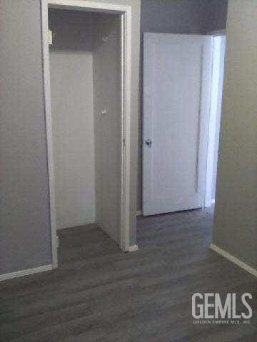1403 Shasta St, Bakersfield, CA 93308 - hallway with baseboards and wood finished floors