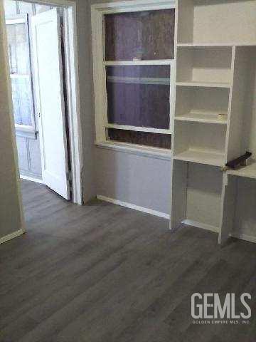 1403 Shasta St, Bakersfield, CA 93308 - unfurnished dining area with baseboards and wood finished floors