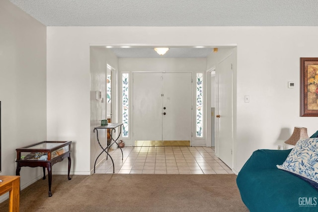 3406 Elm St, Bakersfield, CA 93301 - carpeted entrance foyer with baseboards, tile patterned floors, and a textured ceiling