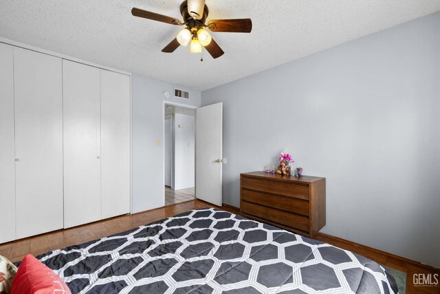 3406 Elm St, Bakersfield, CA 93301 - bedroom with a ceiling fan, wood finished floors, a textured ceiling, a closet, and visible vents