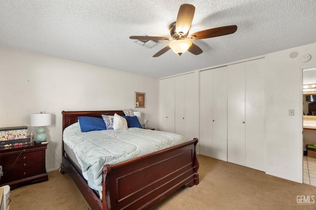 3406 Elm St, Bakersfield, CA 93301 - carpeted bedroom featuring a textured ceiling, multiple closets, a ceiling fan, and visible vents