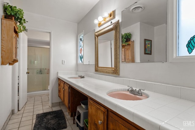 3406 Elm St, Bakersfield, CA 93301 - bathroom with a shower stall, tile patterned floors, double vanity, visible vents, and a sink