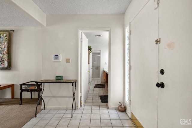 3406 Elm St, Bakersfield, CA 93301 - entrance foyer featuring baseboards, a textured ceiling, and light tile patterned flooring