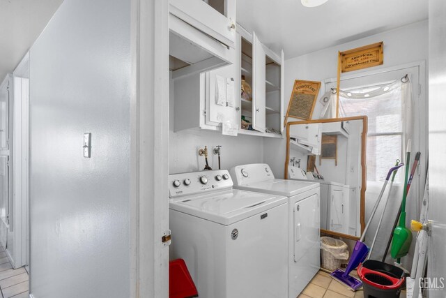3406 Elm St, Bakersfield, CA 93301 - laundry area featuring separate washer and dryer, light tile patterned flooring, and cabinet space