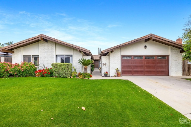 3406 Elm St, Bakersfield, CA 93301 - ranch-style home featuring brick siding, an attached garage, a front lawn, and driveway
