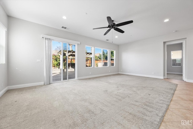 unfurnished room with ceiling fan, a wealth of natural light, and light tile patterned floors