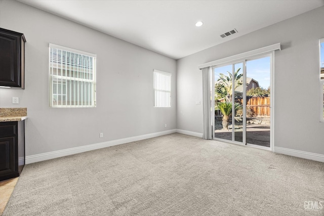 unfurnished living room featuring light carpet