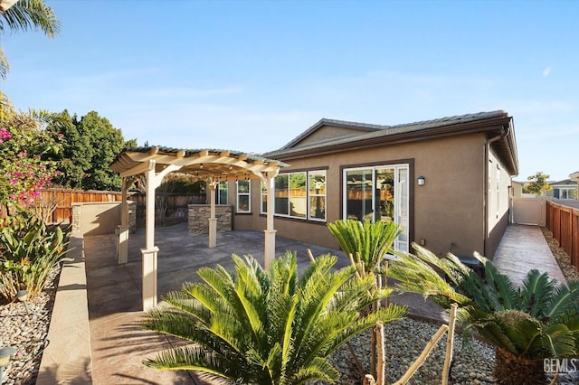 back of property with a patio area and a pergola