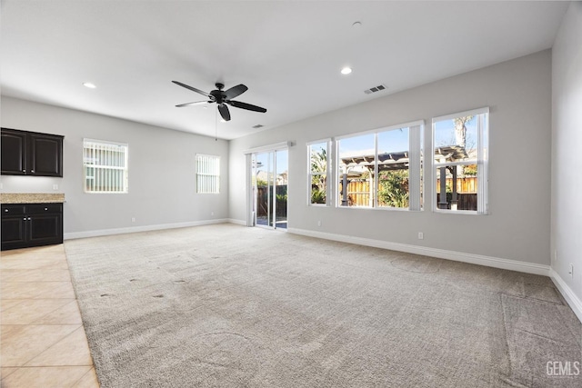 unfurnished living room featuring ceiling fan and light tile patterned flooring