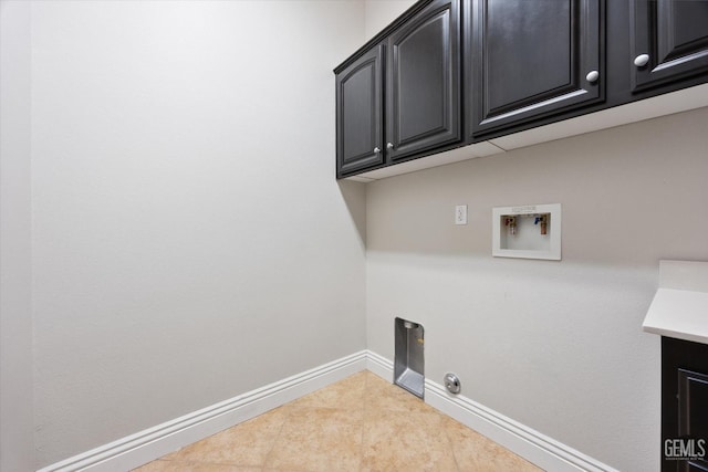 clothes washing area featuring light tile patterned floors, washer hookup, gas dryer hookup, and cabinets