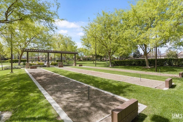 surrounding community with a lawn and a pergola