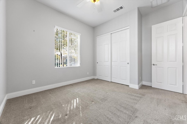 unfurnished bedroom featuring ceiling fan, carpet flooring, and a closet