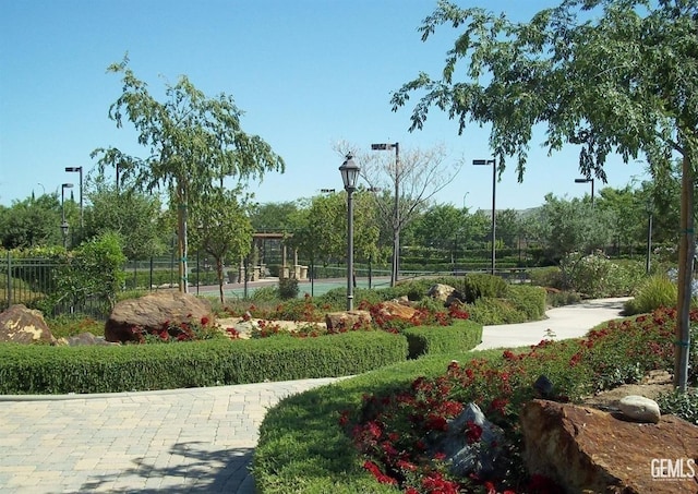 view of community featuring tennis court