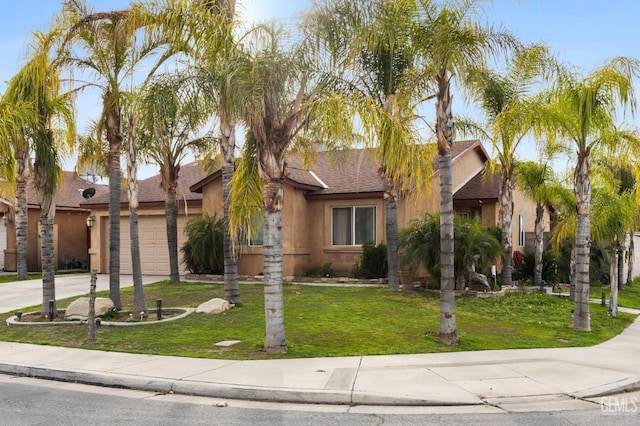 view of front of house with a garage and a front lawn