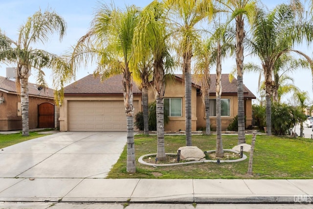 view of front facade with a front yard and a garage