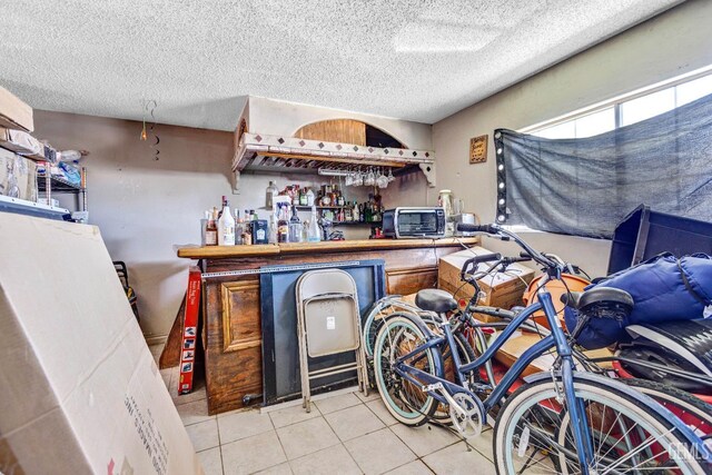 3105 Dore Dr, Bakersfield, CA 93304 - bar area featuring tile patterned floors and a textured ceiling