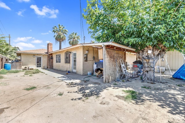 3105 Dore Dr, Bakersfield, CA 93304 - rear view of house featuring stucco siding and a patio area