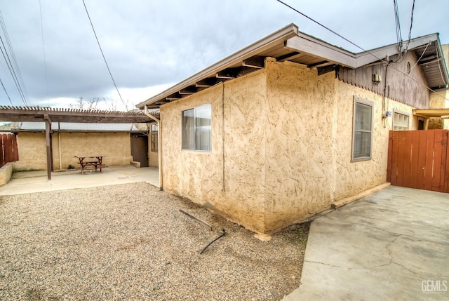 view of side of home with a patio and a pergola