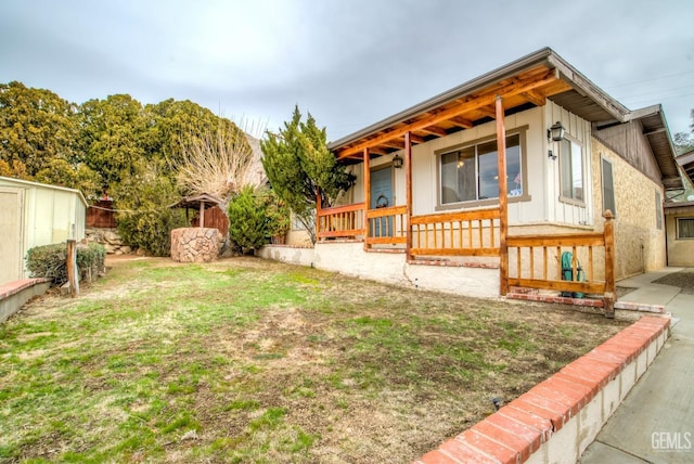 exterior space featuring a porch and a yard