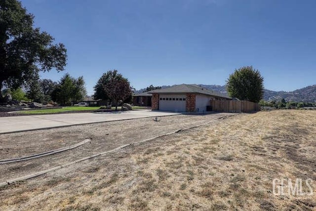 view of side of property featuring a mountain view and a garage