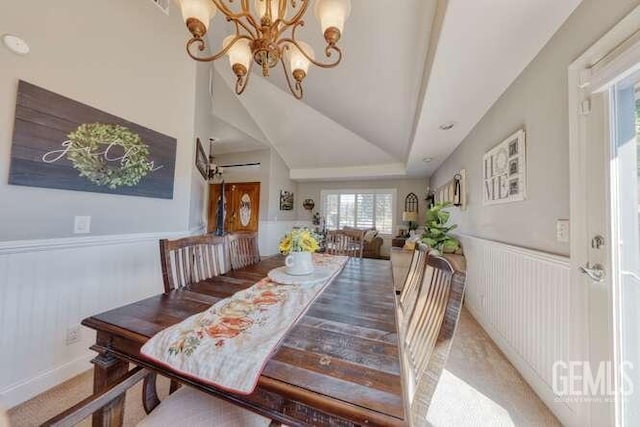 dining room with carpet flooring, a chandelier, and lofted ceiling