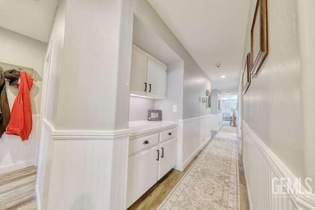 corridor with light hardwood / wood-style floors