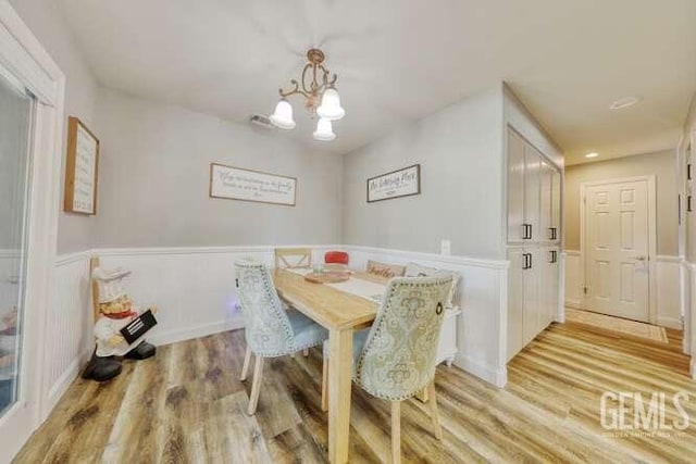 dining area featuring a chandelier and light hardwood / wood-style flooring