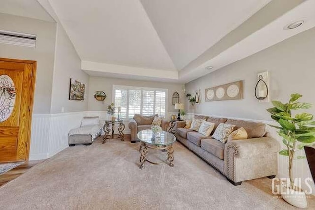 living room featuring light carpet and vaulted ceiling