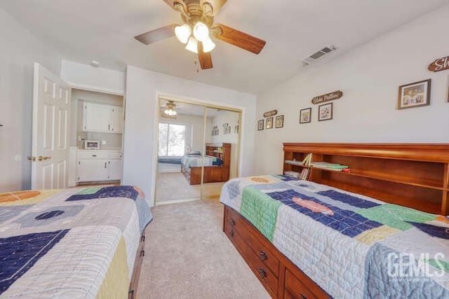 bedroom featuring ceiling fan, a closet, and light colored carpet