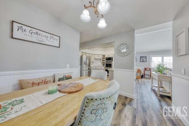 dining room featuring hardwood / wood-style flooring and a notable chandelier