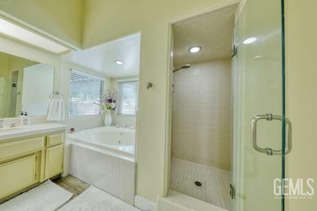 bathroom with vanity and separate shower and tub