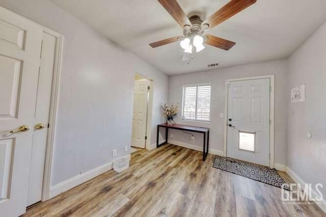 foyer entrance with light hardwood / wood-style flooring and ceiling fan