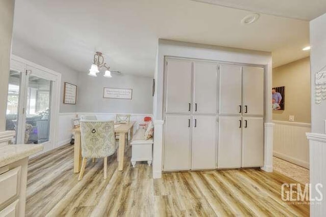 dining area with a chandelier and light hardwood / wood-style floors