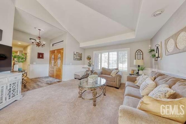 carpeted living room with a notable chandelier