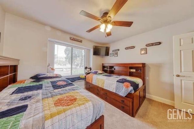 bedroom featuring ceiling fan and light carpet