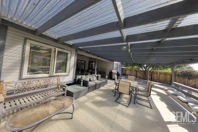 view of patio featuring a pergola, area for grilling, and an outdoor hangout area