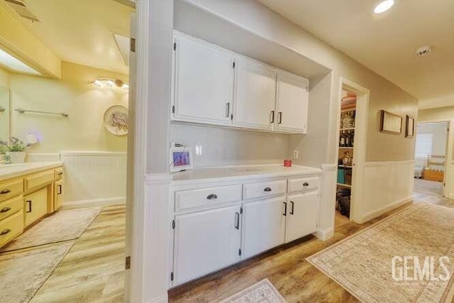 kitchen featuring white cabinets and light hardwood / wood-style floors