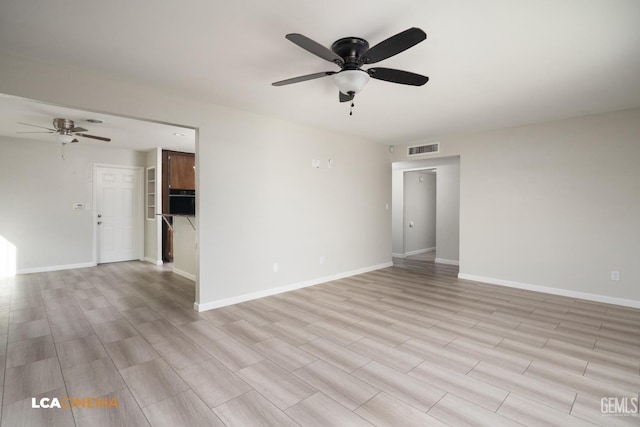 spare room with visible vents, baseboards, and a ceiling fan