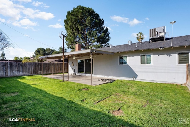 rear view of house featuring a patio area, stucco siding, a lawn, and fence